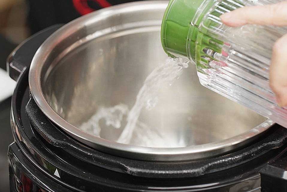 add water into the stainless steel pot of the pressure cooker