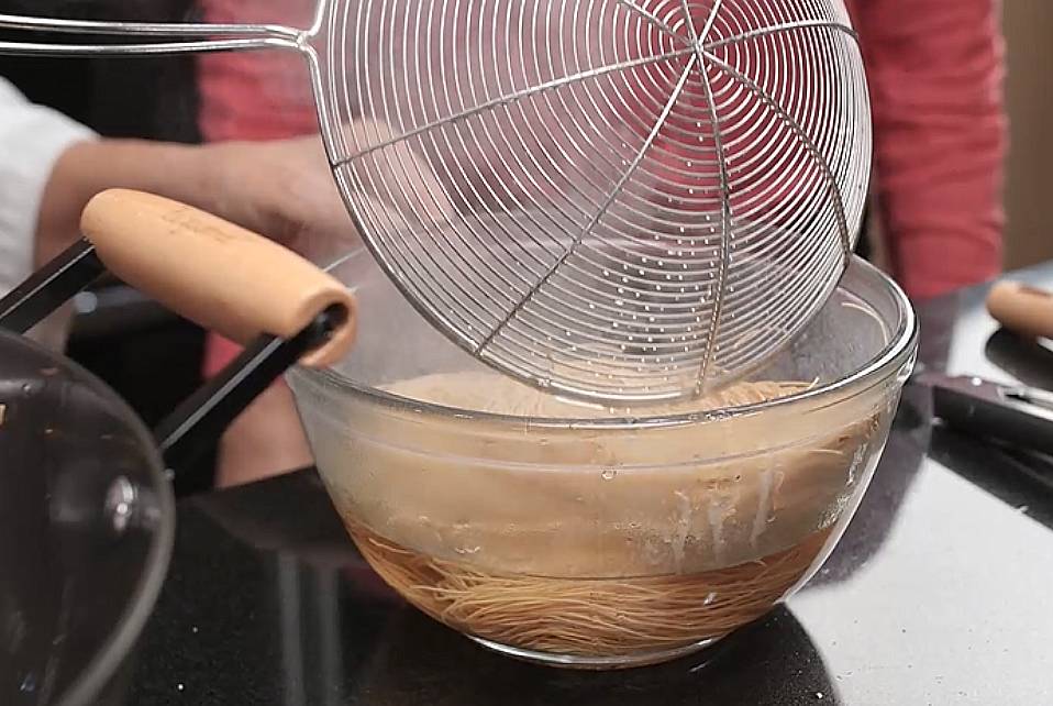 use strainer to scoop the noodles out